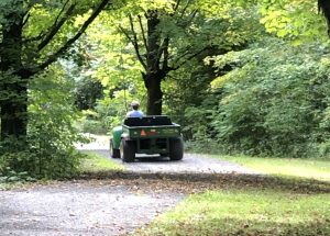 Kathy Gutscher driving away in 4-wheeler