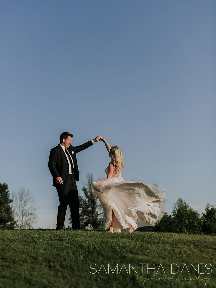 wedding couple dancing on the grass